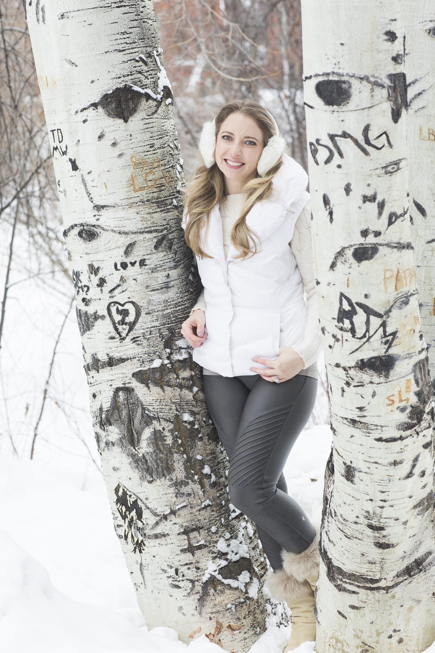 Jen outside in snow at base of trees